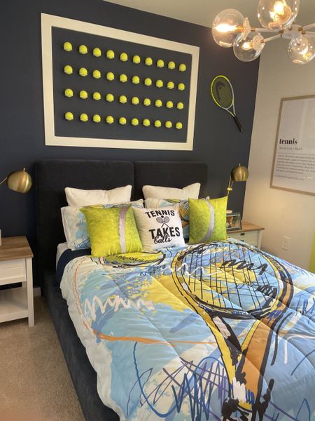 A playful bedroom with a tennis theme, featuring a colorful bedspread and creative wall art with tennis balls.