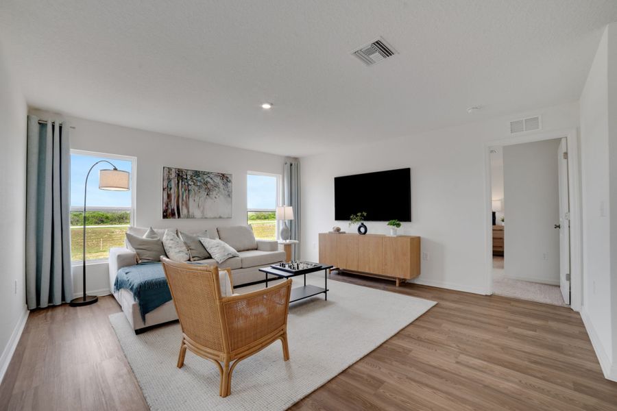 A living room with a wood floor.