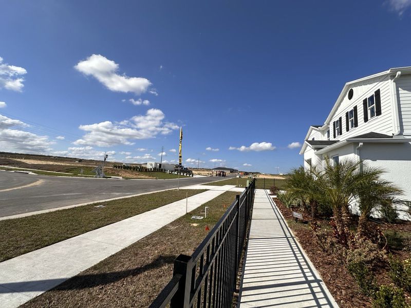 A KB Home sales center with model homes and bright blue skies in Landings at Lake Mabel Loop by KB Home (Dundee, FL).