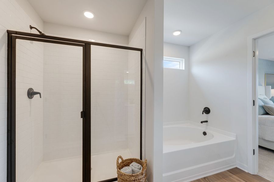 A bathroom with a tub and shower.