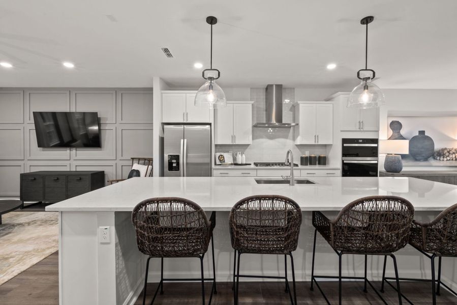 Bright spacious kitchen with large eat-in island in Prestwick new home construction at Apex, NC