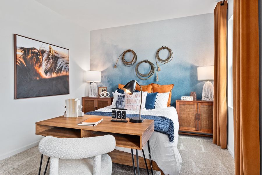 A bedroom with a bed and a desk. A bedroom with a bed and a desk.