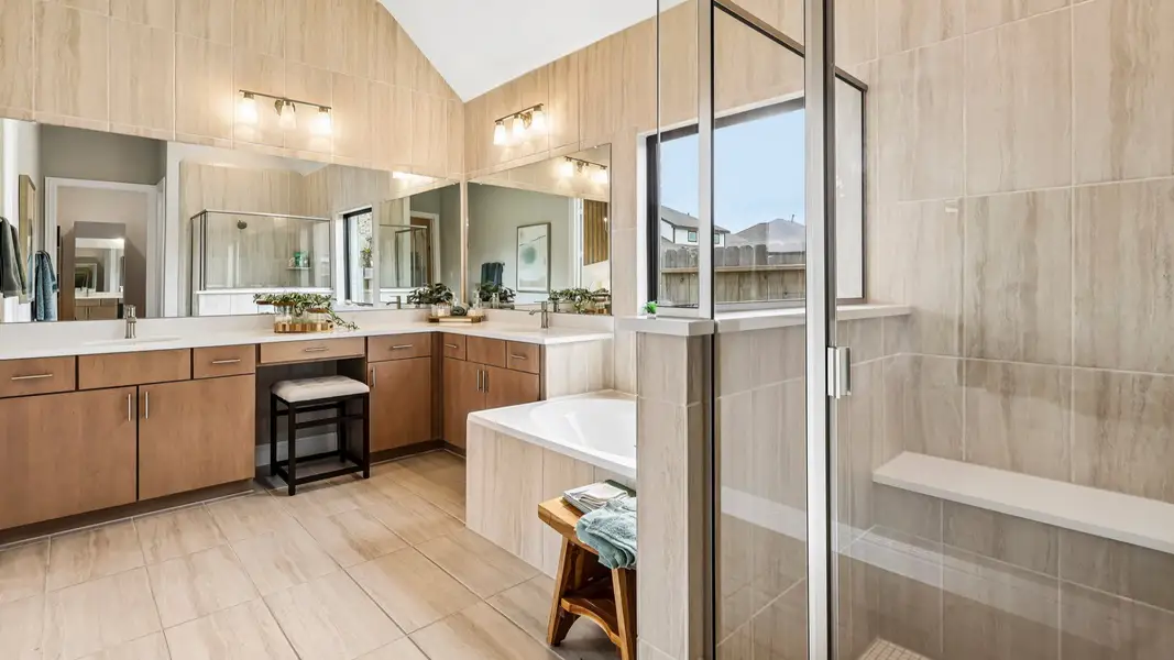 Indulge in the Sunterra community’s luxurious bathroom with a sleek glass shower and refined wood cabinetry. Indulge in the Sunterra community’s luxurious bathroom with a sleek glass shower and refined wood cabinetry.