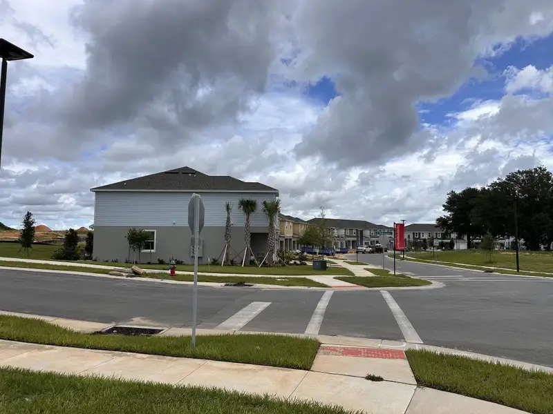 A modern neighborhood with elegant homes under cloudy skies in Waterstone by Taylor Morrison, Mascotte, FL.