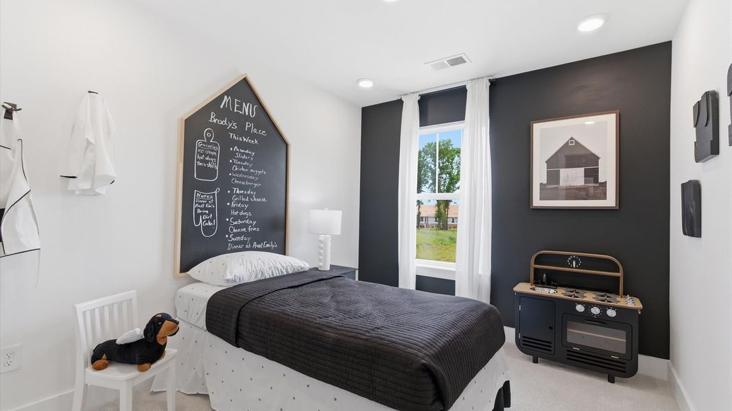 Inviting bedroom with tasteful finishes and a large window that creates a fresh, open ambiance at this villa in Anderson, SC Inviting bedroom with tasteful finishes and a large window that creates a fresh, open ambiance at this villa in Anderson, SC