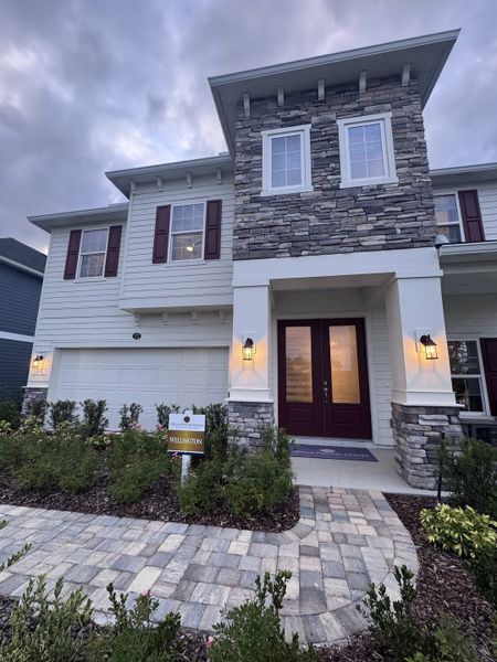 A beautiful two-story stone and siding home in Brook Forest by Dream Finders Homes (St. Augustine, FL).