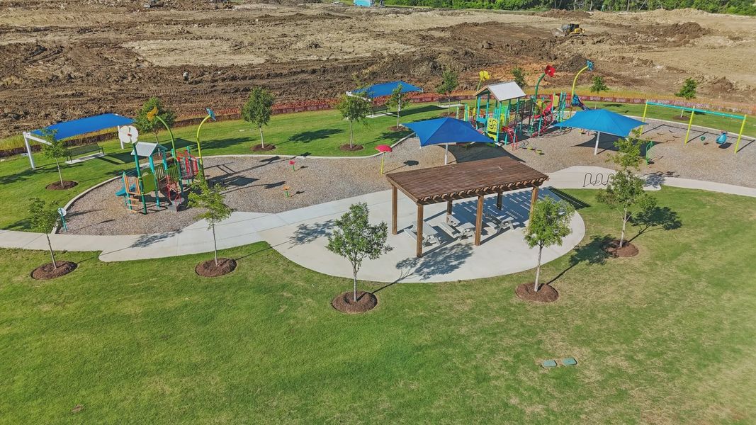 Vibrant playground with shaded areas and lush green lawn in Wildflower Ranch offers premium outdoor leisure. Vibrant playground with shaded areas and lush green lawn in Wildflower Ranch offers premium outdoor leisure.