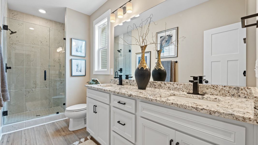 Highly functional and elegant en-suite with dual vanities, tiled walk-in shower, and refined finishes in Fountain Inn, SC