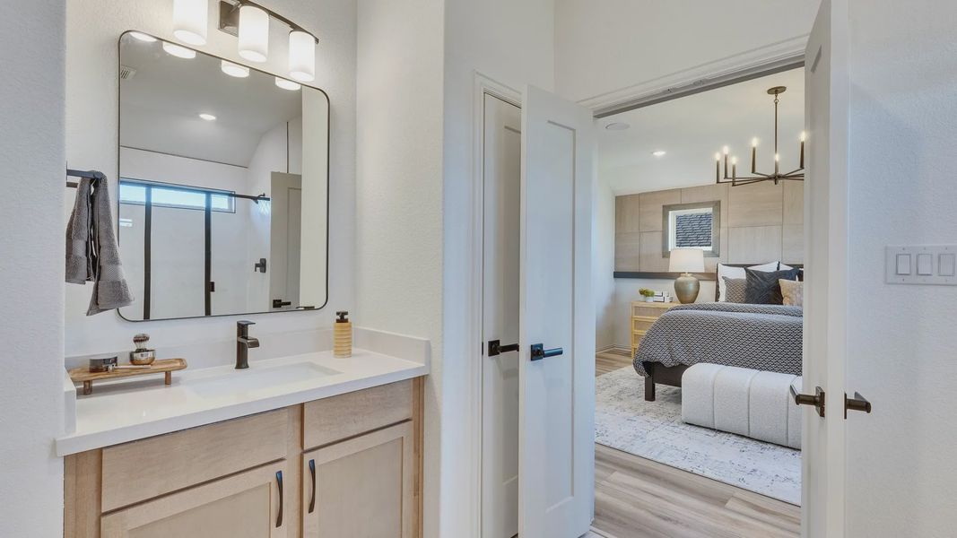 Elegant bathroom with chic fixtures transitions to a refined bedroom suite in Briarwood.