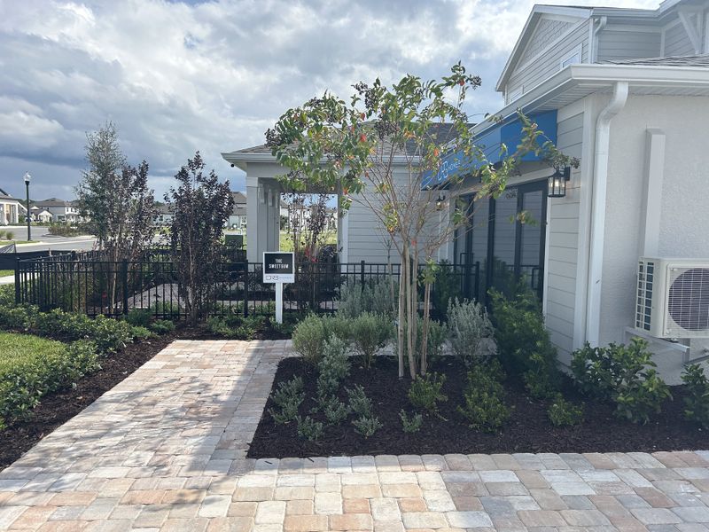 A charming home with landscaped yard and brick path in Trailside by DRB Homes (Mount Dora, FL).