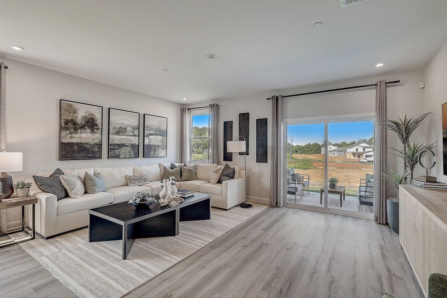 A living room with a large window. A living room with a large window.