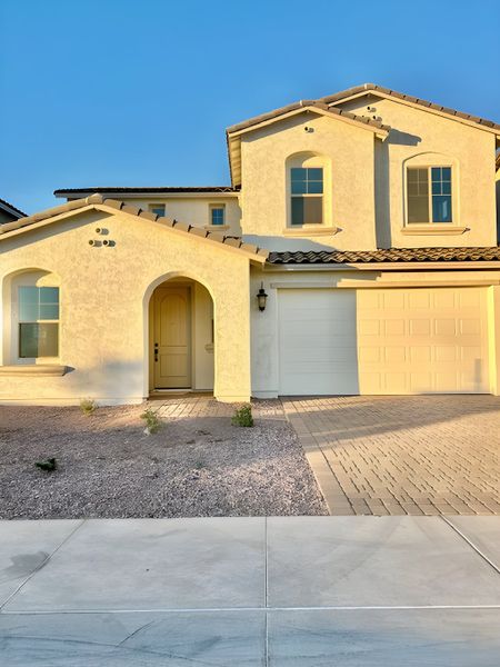 Elegant stucco home with arched entry in Hawes Crossing Discovery Collection by Taylor Morrison (Mesa, AZ). Elegant stucco home with arched entry in Hawes Crossing Discovery Collection by Taylor Morrison (Mesa, AZ).