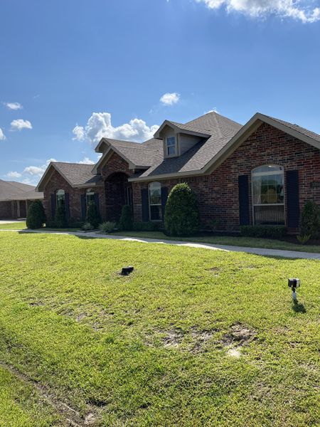 Charming brick home with manicured lawn in Pedregal by Cervelle Homes, San Leon, TX.