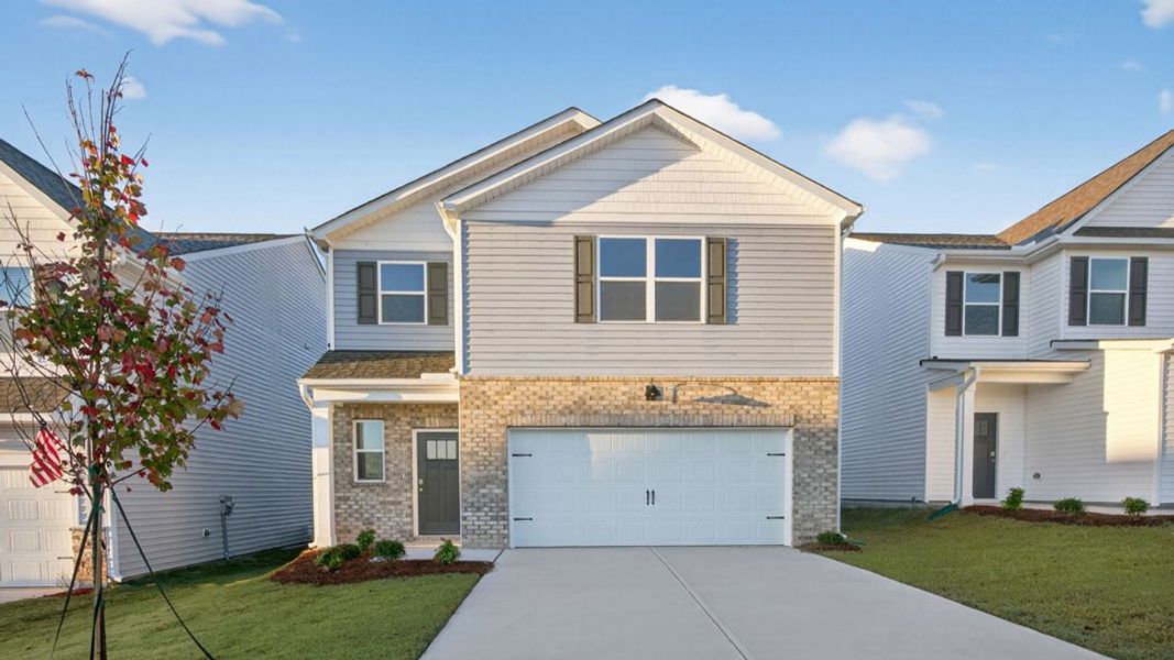 Front exterior of a home in the The Grove at Matthews Landing community, located in Fuquay Varina, NC (Image 18).
