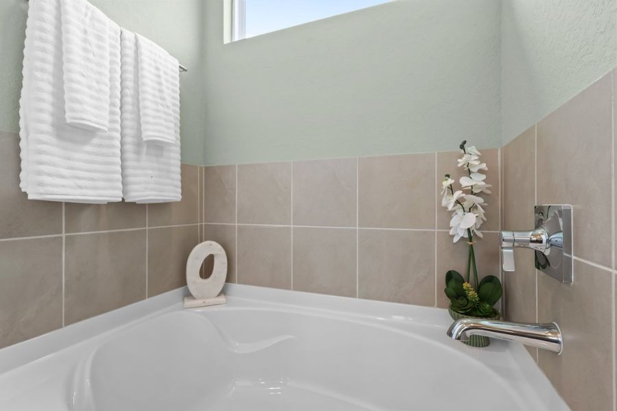 A bathroom with a bathtub and towels. A bathroom with a bathtub and towels.
