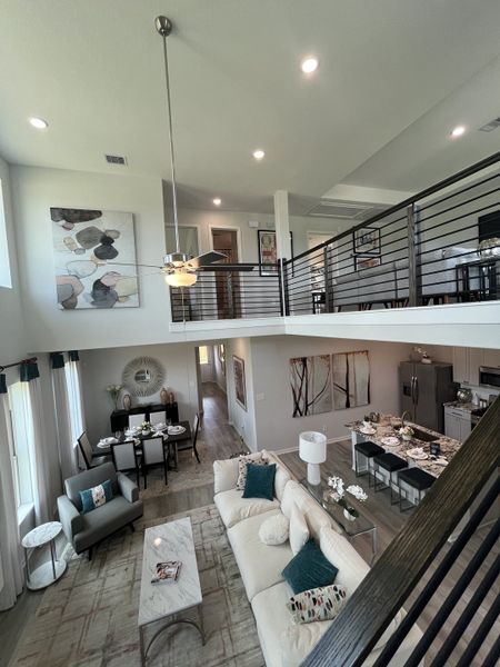 A spacious open-concept living area with modern decor, featuring a cozy sofa, stylish dining set, and sleek kitchen island. A spacious open-concept living area with modern decor, featuring a cozy sofa, stylish dining set, and sleek kitchen island.