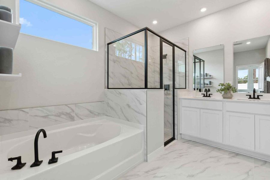 A bathroom with a tub and sink. A bathroom with a tub and sink.