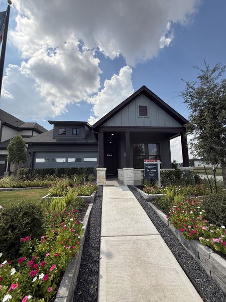 A charming home with lush landscaping in Austin Point by David Weekley Homes (Richmond, TX).