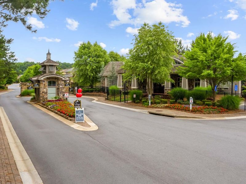 Entrance to the The Village at Towne Lake community in Woodstock, GA, featuring signage and landscaping (Image 15). Entrance to the The Village at Towne Lake community in Woodstock, GA, featuring signage and landscaping (Image 15).