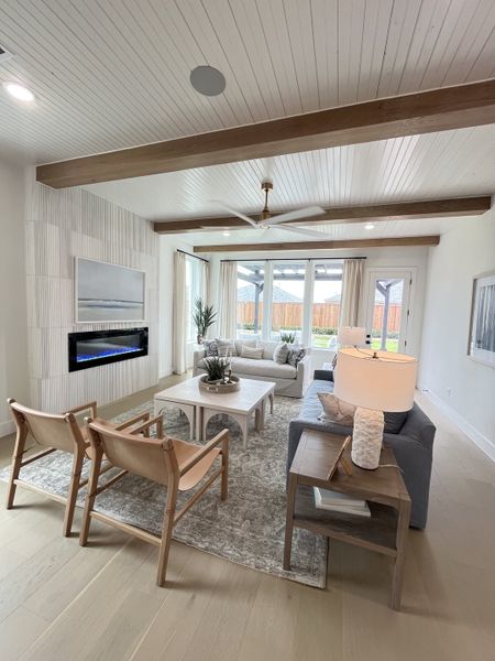 A cozy living room with wood beams, stylish furniture, and a sleek fireplace. Perfect for relaxing and entertaining. A cozy living room with wood beams, stylish furniture, and a sleek fireplace. Perfect for relaxing and entertaining.