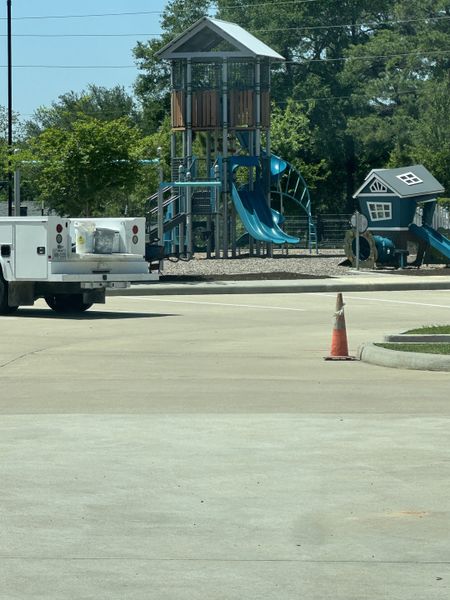 A vibrant playground with slides and climbing structures in Westridge Cove by Coventry Homes (Conroe, TX).