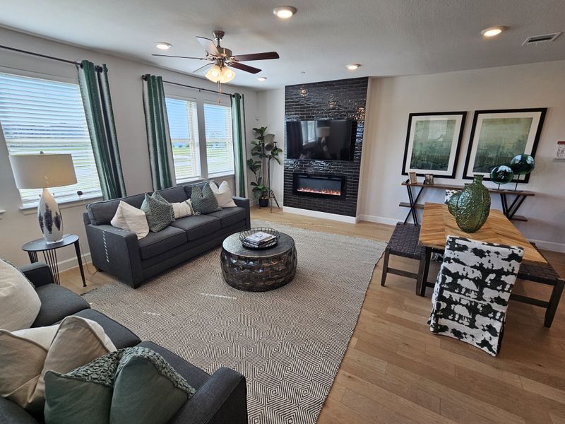 A cozy living room with a sleek fireplace, modern decor, and ample natural light, creating a welcoming ambiance.