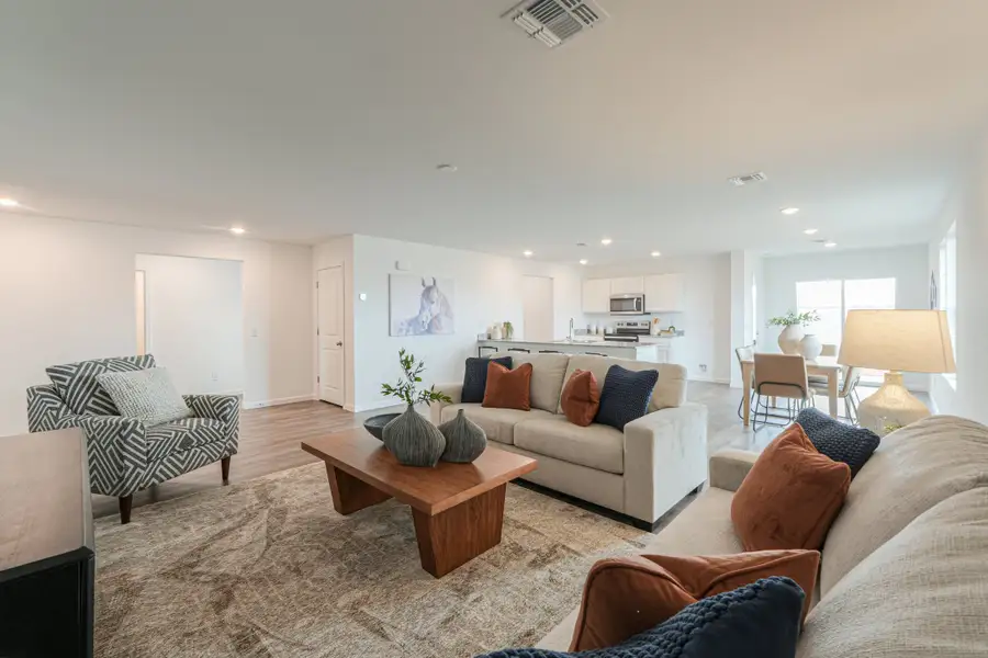 A living room with a couch and a coffee table. A living room with a couch and a coffee table.