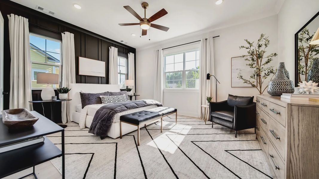 Shelton Square bedroom boasts chic black accent wall, elegant furnishings, and expansive natural light.