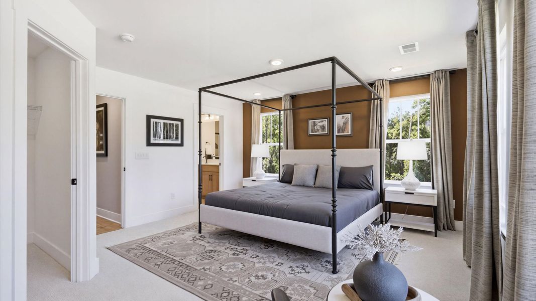Eye-catching details and elegant finishes in the vibrant primary suite of this select home at the Brookland Place community