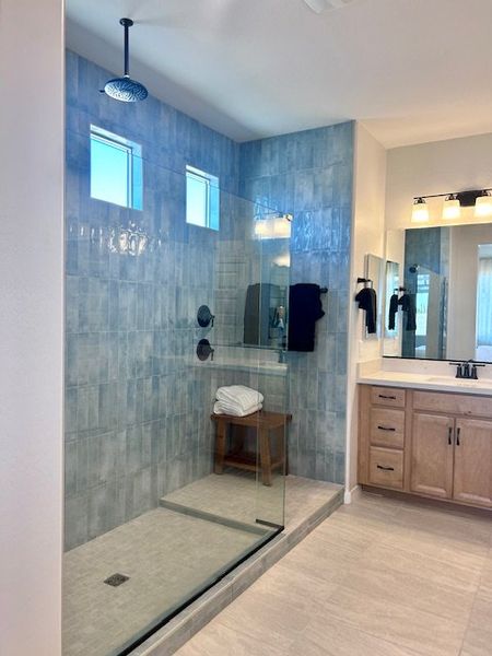 A sleek bathroom with a spacious glass shower, blue tiles, and a stylish vanity, offering modern elegance and functionality. A sleek bathroom with a spacious glass shower, blue tiles, and a stylish vanity, offering modern elegance and functionality.