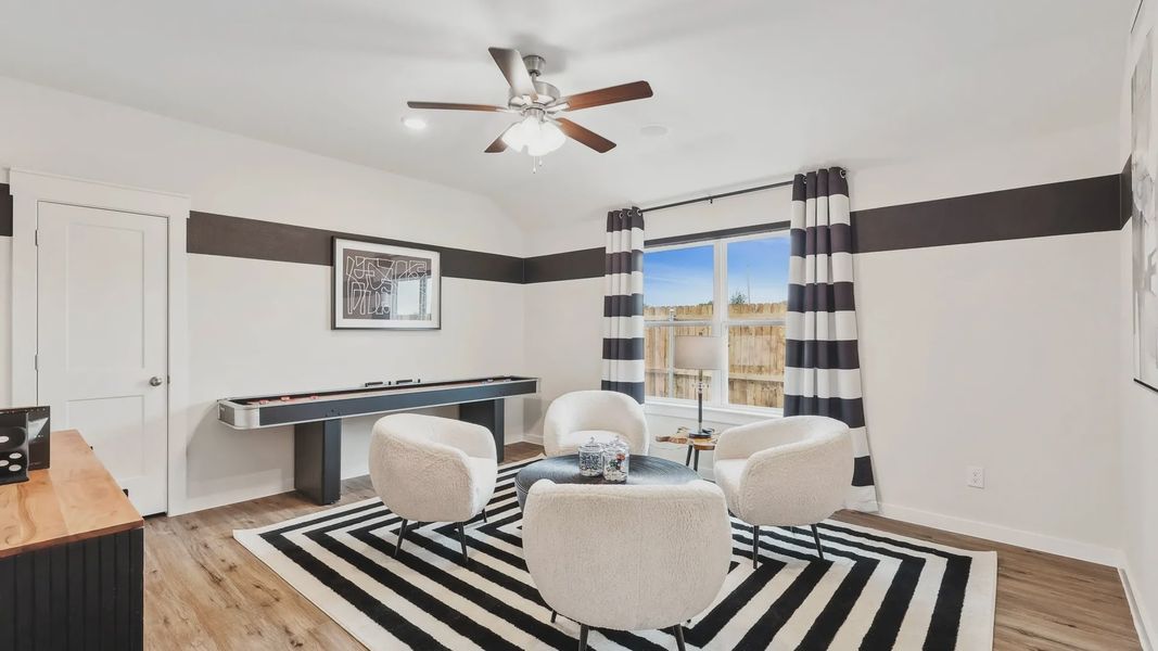 Elegant window and modern decor define this Simpson Crossing living room's allure.