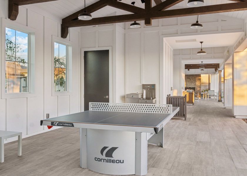 A room with a pool table and a large window. A room with a pool table and a large window.