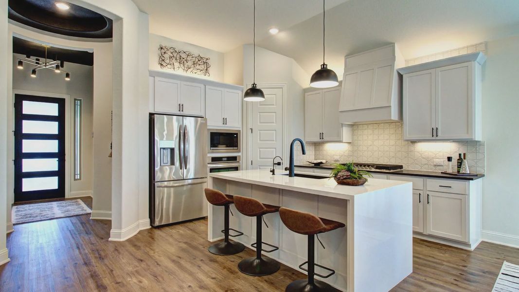 Bask in luxury with quartz countertops, a grand island, and sophisticated lighting in Meyer Ranch. Bask in luxury with quartz countertops, a grand island, and sophisticated lighting in Meyer Ranch.