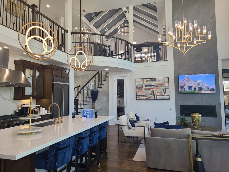 A luxurious open-concept living area with a modern kitchen, elegant lighting, and stylish furnishings.