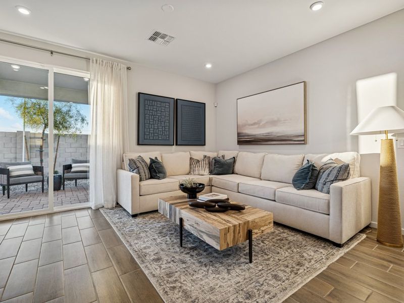 A living room with a white couch and a coffee table.