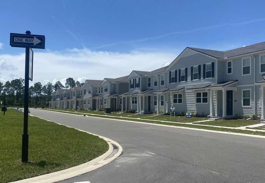 Modern townhomes with sleek siding and manicured lawns in RiverTown - Meadows by Mattamy Homes (St. Johns, FL).