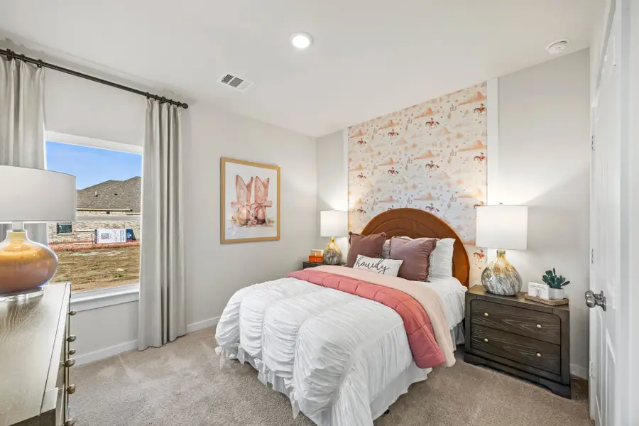 A bedroom with a bed and a window.