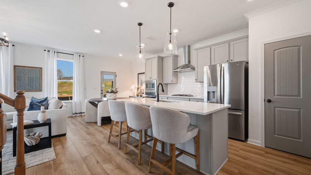 Bright open kitchen with quartz island and modern finishes in Langley Overlook townhome in Loganville, GA. Bright open kitchen with quartz island and modern finishes in Langley Overlook townhome in Loganville, GA.