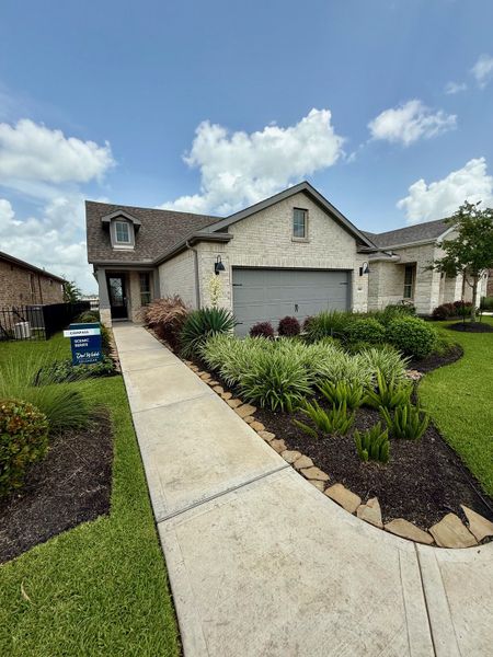 A charming brick home with a landscaped yard in Del Webb Fulshear by Del Webb (Fulshear, TX). A charming brick home with a landscaped yard in Del Webb Fulshear by Del Webb (Fulshear, TX).
