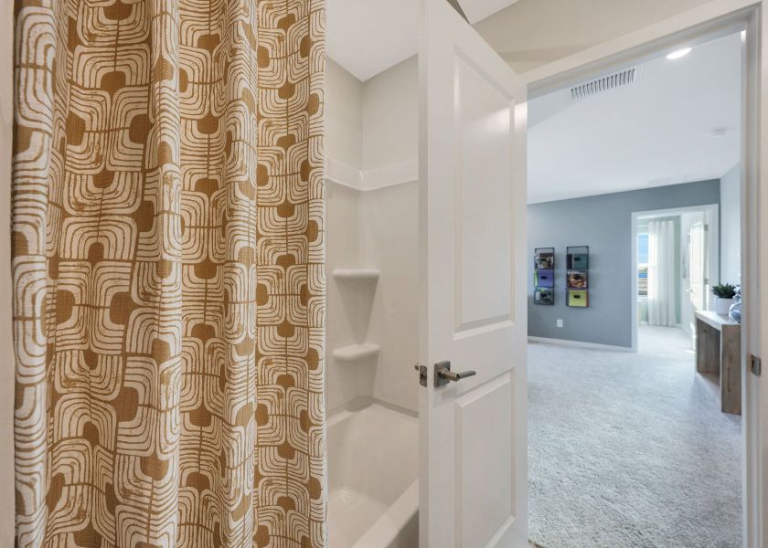 A bathroom with a shower curtain. A bathroom with a shower curtain.