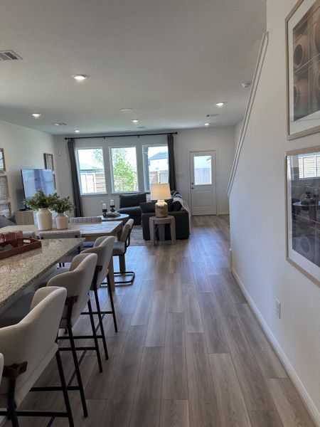 An inviting open floor plan with light wood flooring, cozy seating, and a spacious dining area, perfect for gatherings. An inviting open floor plan with light wood flooring, cozy seating, and a spacious dining area, perfect for gatherings.