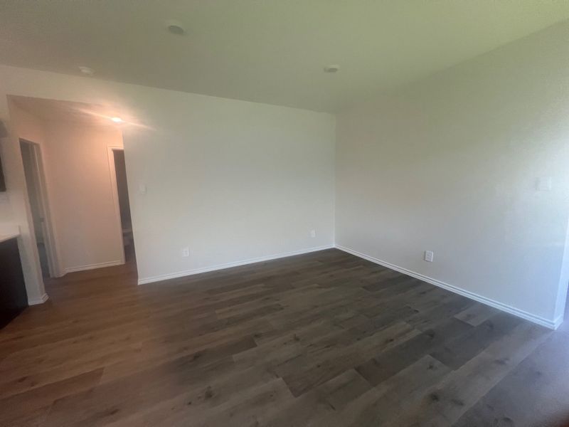 A spacious room with wood floors and neutral walls, offering a versatile canvas for any decor. A spacious room with wood floors and neutral walls, offering a versatile canvas for any decor.
