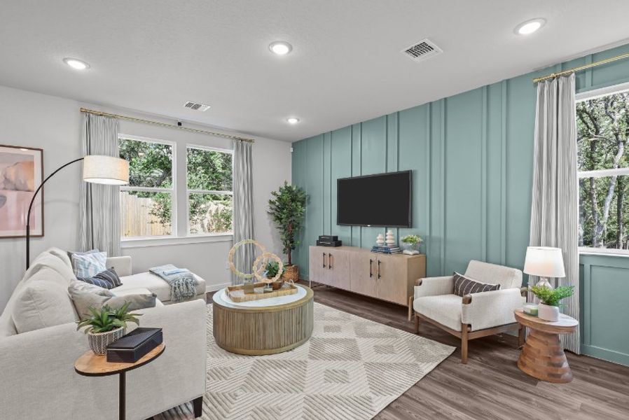 A living room with a tv and couches. A living room with a tv and couches.