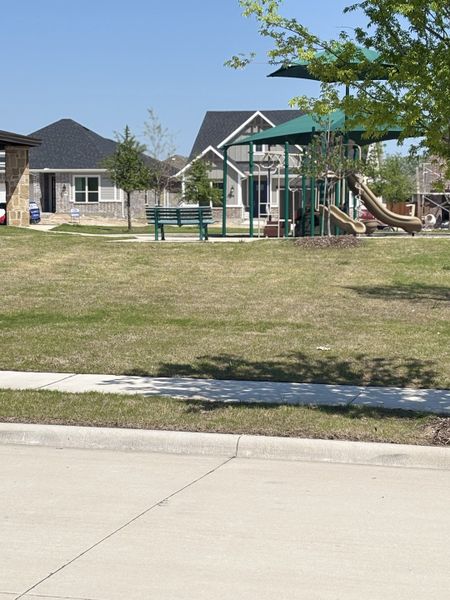 A charming community park in Bayside by Mattamy Homes, featuring playgrounds and green spaces, invites outdoor fun in Rowlett, TX.