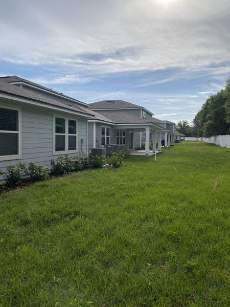 Modern homes with spacious yards and white fences in Wells Landing by Centex, Jacksonville, FL.