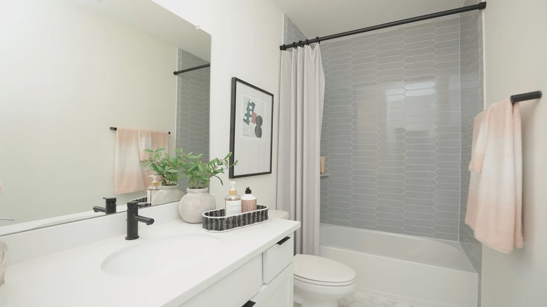 Stylish bathroom with elegant hexagon tiles and sleek matte black fixtures in prestigious Brookewater community. Stylish bathroom with elegant hexagon tiles and sleek matte black fixtures in prestigious Brookewater community.