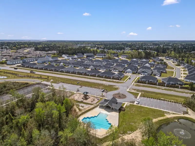 Aerial view of the Riverwalk Pointe at Mallory Creek - Single Family community in Leland, NC, showing layout and nearby surroundings (Image 1). Aerial view of the Riverwalk Pointe at Mallory Creek - Single Family community in Leland, NC, showing layout and nearby surroundings (Image 1).