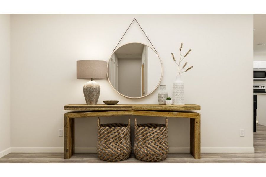 A table with a mirror and a lamp on it.