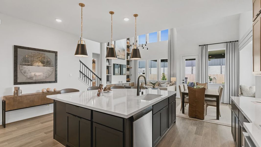 Sophisticated kitchen with marble island and pendant lights. Vaulted ceilings enhance Beamer Villas luxury. Sophisticated kitchen with marble island and pendant lights. Vaulted ceilings enhance Beamer Villas luxury.