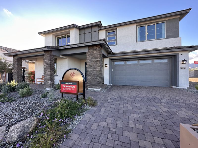 A contemporary two-story home with stone accents and a sleek garage in Tirreno at IronWing by Beazer Homes (Litchfield Park, AZ).